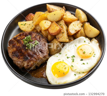 fried egg and fried potatoes on a black plate 132994270