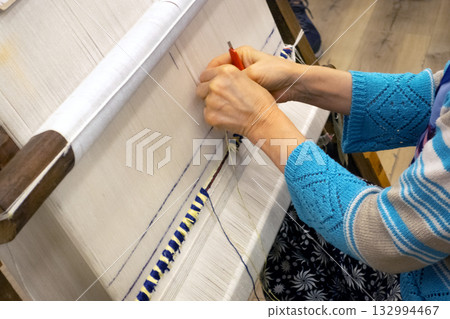 hands weaving traditional turkish carpet with colorful wool 132994467