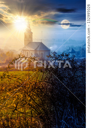 old church in the village in autumn. day and night time change concept. view of countryside landscape from a hill in haze with sun and moon. empty rural fields. duality and transition template old church in the village in autumn. day and night time change concept. view of countryside landscape from a hill in haze with sun and moon. empty rural fields. duality and transition template 132995026