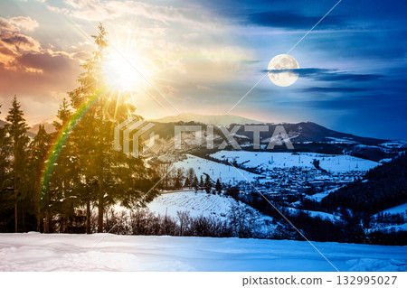 village in mountains. day and night time change concept. winter landscape covered with snow with sun and moon at twilight. trees on rolling hills. duality and transition template village in mountains. day and night time change concept. winter landscape covered with snow with sun and moon at twilight. trees on rolling hills. duality and transition template 132995027