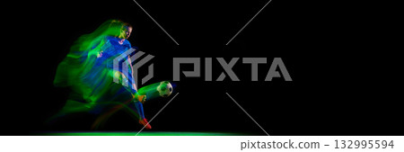 Female athlete controlling soccer ball in turquoise and pink motion light. Banner 132995594