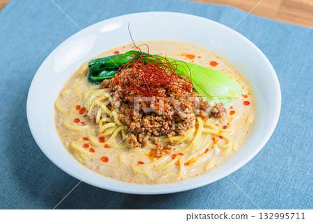 Soy milk sesame dandan noodles, Dandan noodles and bok choy served in a white bowl Soy milk sesame dandan noodles, Dandan noodles and bok choy served in a white bowl 132995711
