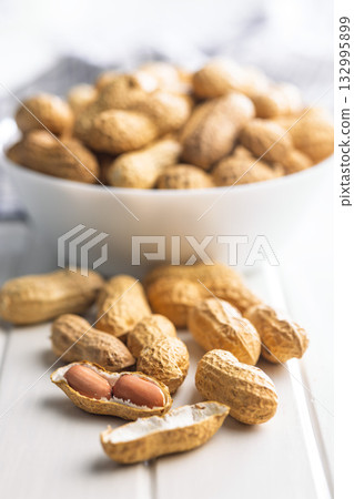 Peanuts in shell. Groundnuts on white table. Peanuts in shell. Groundnuts on white table. 132995899