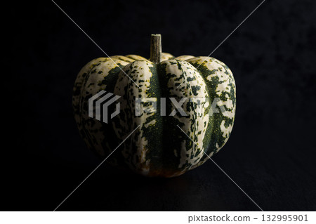 Sweet dumpling pumpkin on black table. Sweet dumpling pumpkin on black table. 132995901