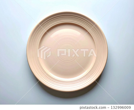 Elegant dining. Ceramic plate with a classic beige design on a white background. Porcelain kitchenware. Close-up. Top view. 132996009