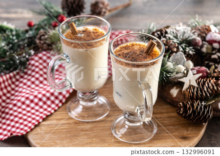 Eggnog with Cinnamon and Christmas Decorations Eggnog with Cinnamon and Christmas Decorations 132996091