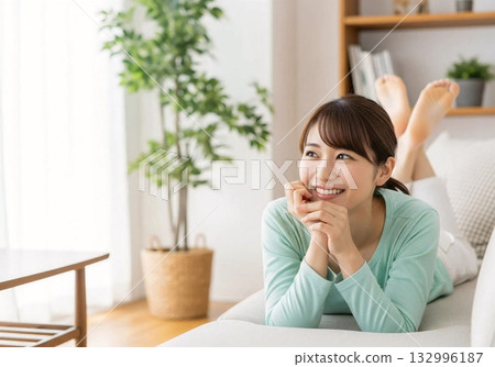 Smiling woman relaxing on the sofa Stylish background 132996187