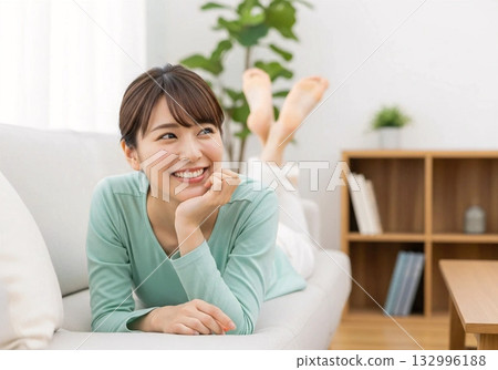 Smiling woman relaxing on the sofa Stylish background Smiling woman relaxing on the sofa Stylish background 132996188