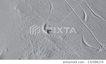 Skier leaving tracks on fresh snow, sequence 132996234