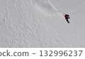 Snowboarder riding fresh powder snow on mountainside 132996237