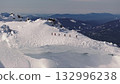 Mountaineers walking on snowy mountain ridge 132996238