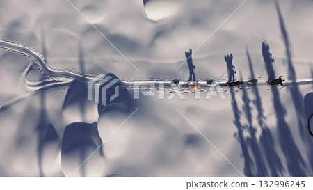 Explorers pulling sleds across snowy landscape 132996245