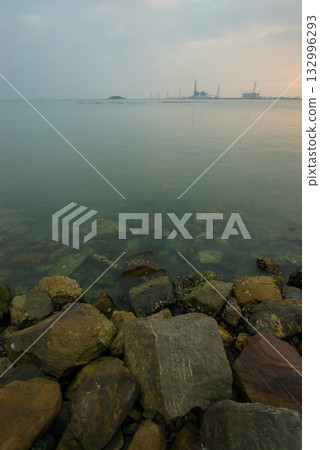 Soft waves on a rocky beach in the evening Soft waves on a rocky beach in the evening 132996293