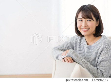 Smiling woman relaxing on sofa, copy space Smiling woman relaxing on sofa, copy space 132996367