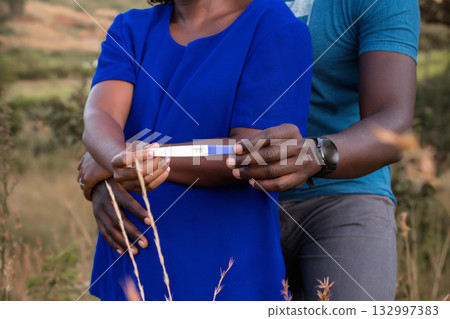 Needle medicinal pregnancy maternity baby bump couple hands details 132997383