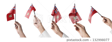 The Bermuda flag in hand in different angles on a white background 132998077