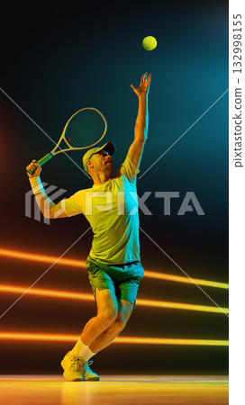 Tennis player serving ball with upward reach and perfect timing under lights. Handmade collage Tennis player serving ball with upward reach and perfect timing under lights. Handmade collage 132998155