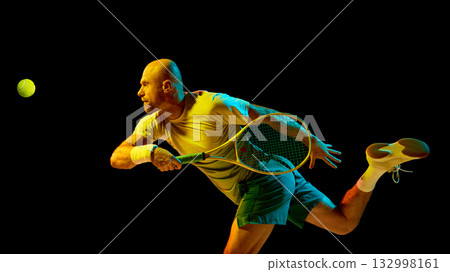 Energetic tennis player hitting forehand illuminated by cinematic lighting Energetic tennis player hitting forehand illuminated by cinematic lighting 132998161