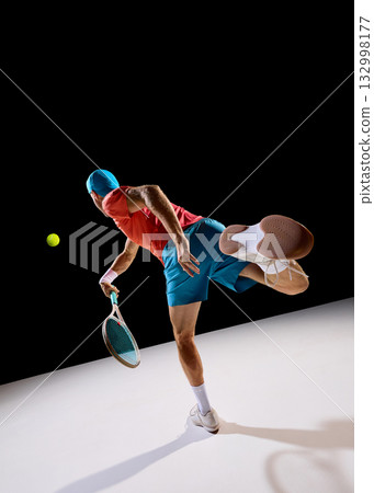Determined tennis player following ball with focus and body control 132998177