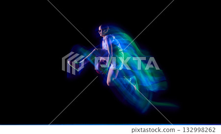 Basketball player performing aerial trick in neon motion trail. Basketball player performing aerial trick in neon motion trail. 132998262