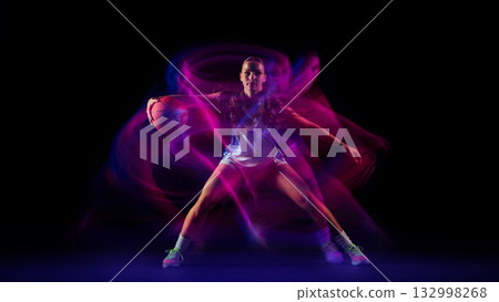 Basketball player surrounded by pink and blue energy motion. Basketball player surrounded by pink and blue energy motion. 132998268