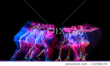 Basketball player in multiple dribble motion with pink and blue lights. 132998278