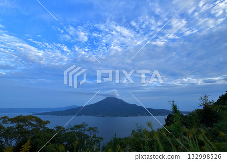 View of Sakurajima with smoke rising from the volcano near Sugiyama Park in Kagoshima View of Sakurajima with smoke rising from the volcano near Sugiyama Park in Kagoshima 132998526