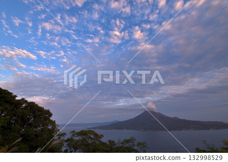 View of Sakurajima with smoke rising from the volcano near Sugiyama Park in Kagoshima 132998529