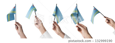 The Aruba flag in hand in different angles on a white background 132999190