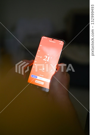 Smartphone connecting to heating system. Remote home control system on a smartphone. smart home 132999493