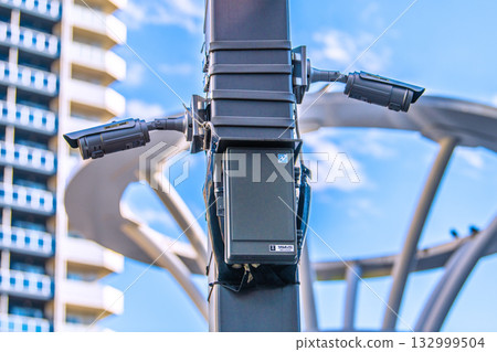 Tokyo cityscape in Japan: Security cameras on street corners. View of the north exit of Otsuka Station, security cameras and wall boxes in the station square. Tokyo cityscape in Japan: Security cameras on street corners. View of the north exit of Otsuka Station, security cameras and wall boxes in the station square. 132999504