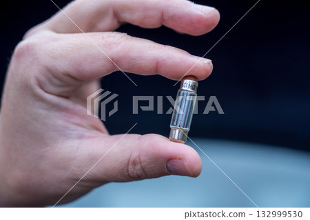 Halogen car new and old lamp bulb. Male hand holding car parts 132999530