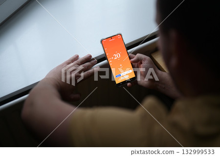 Smartphone connecting to heating radiator. Remote home control system on a smartphone. 132999533