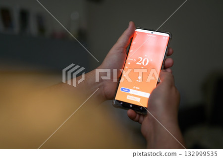 Smartphone connecting to heating system. Remote home control system on a smartphone. smart home 132999535