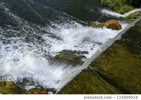 Seething water at a dam on the Nizhny Suzun River in Siberia in summer 133000018