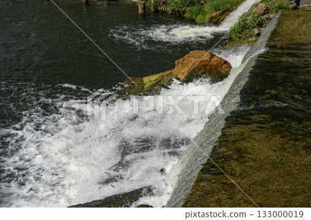 Seething water at a dam on the Nizhny Suzun River in Siberia in summer 133000019