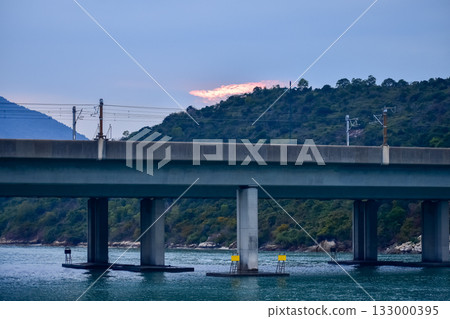 The seascape from the waterfront in Tung Chung, Hong Kong at sunset. Travel and nature scene. The seascape from the waterfront in Tung Chung, Hong Kong at sunset. Travel and nature scene. 133000395