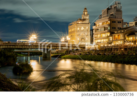 The glittering streets of Kyoto, Japan. Night view of the Kamo River, Kyoto, around Shijo Ohashi Bridge The glittering streets of Kyoto, Japan. Night view of the Kamo River, Kyoto, around Shijo Ohashi Bridge 133000736