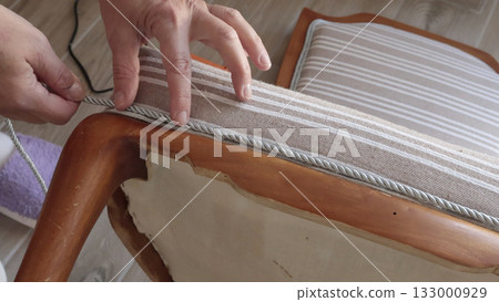 Anonymous person glues decorative braid. Antique furniture restoration. Crafts and hobbies. Anonymous person glues decorative braid. Antique furniture restoration. Crafts and hobbies. 133000929
