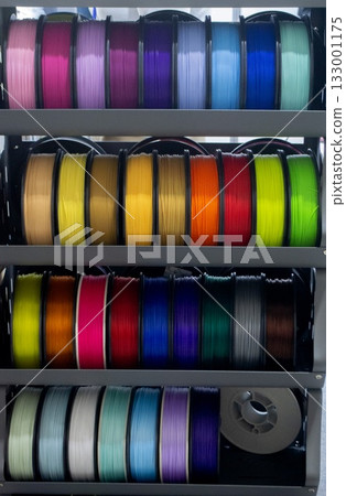Many spools with multi-colored plastic for 3D printing. Spools with pink, red, burgundy, purple, yellow, orange blue plastic wire for 3D printer. Components for 3D printing. Accessories for 3D printer Many spools with multi-colored plastic for 3D printing. Spools with pink, red, burgundy, purple, yellow, orange blue plastic wire for 3D printer. Components for 3D printing. Accessories for 3D printer 133001175