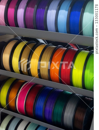 Many spools with multi-colored plastic for 3D printing. Spools with pink, red, burgundy, purple, yellow, orange blue plastic wire for 3D printer. Components for 3D printing. Accessories for 3D printer Many spools with multi-colored plastic for 3D printing. Spools with pink, red, burgundy, purple, yellow, orange blue plastic wire for 3D printer. Components for 3D printing. Accessories for 3D printer 133001178