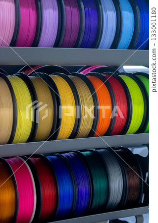 Many spools with multi-colored plastic for 3D printing. Spools with pink, red, burgundy, purple, yellow, orange blue plastic wire for 3D printer. Components for 3D printing. Accessories for 3D printer Many spools with multi-colored plastic for 3D printing. Spools with pink, red, burgundy, purple, yellow, orange blue plastic wire for 3D printer. Components for 3D printing. Accessories for 3D printer 133001180