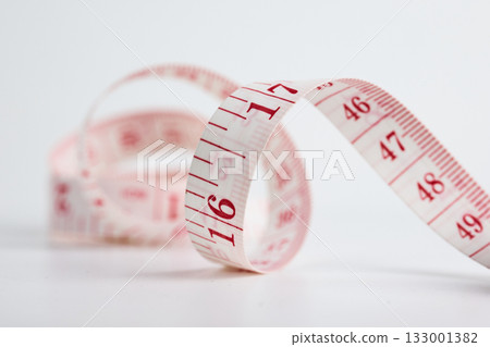 A flexible tape measures with clear numbers. A flexible tape measures with clear numbers. 133001382