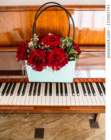 front view of roses in bag on keyboard of piano front view of roses in bag on keyboard of piano 133001743