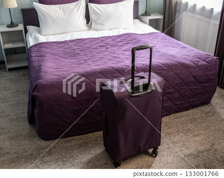 purple suitcase and double bed made with linens purple suitcase and double bed made with linens 133001766