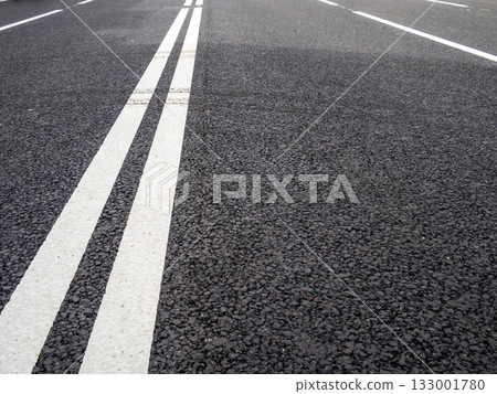 double solid line on new asphalt surface of street 133001780