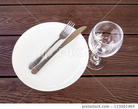 white plate with knife and fork and empty glass 133001964