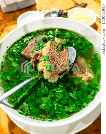 Georgian Khashlama soup n bowl on wooden table Georgian Khashlama soup n bowl on wooden table 133001990