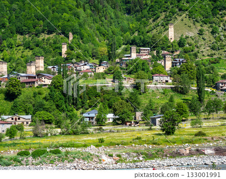 view of Mestia townlet on green slope in morning 133001991