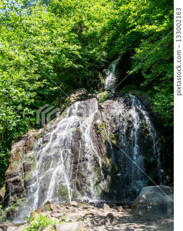 waterfall on mountain pass in Svaneti in summer 133002163